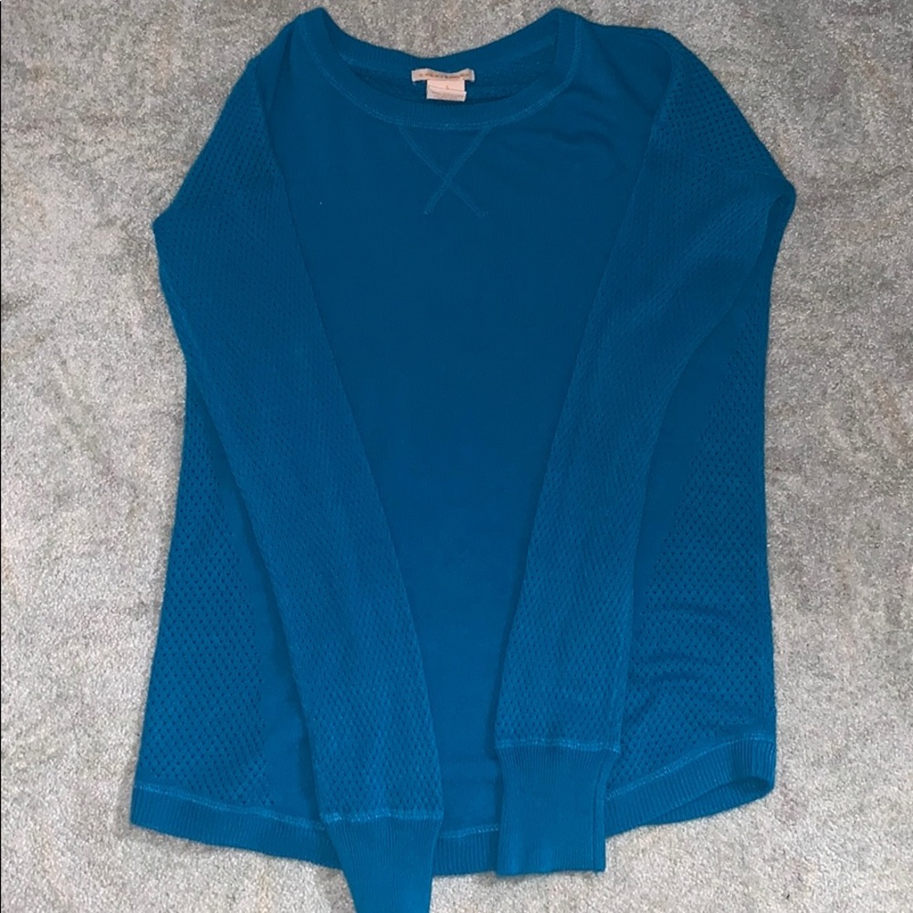 Blue long sleeve sweater with small holes.